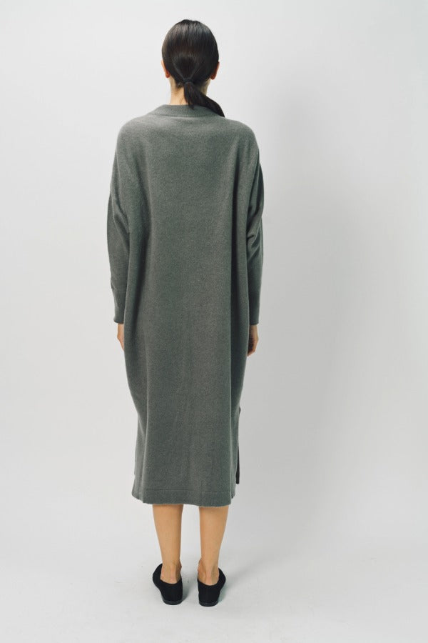 Back view of storm iconic cashmere dress on model wearing loafers, against a white background.