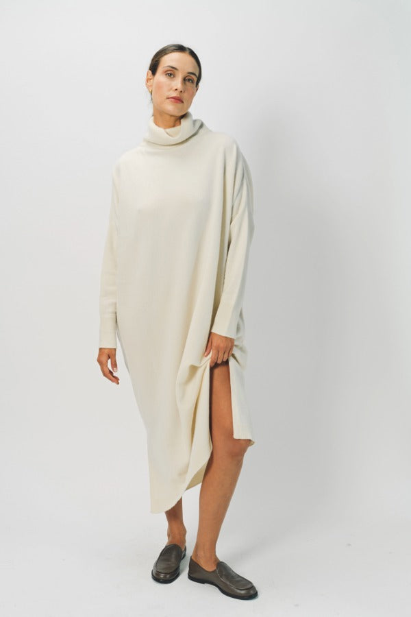 Alternate front view of bone iconic cashmere t-neck dress on model wearing loafers, against a white background.