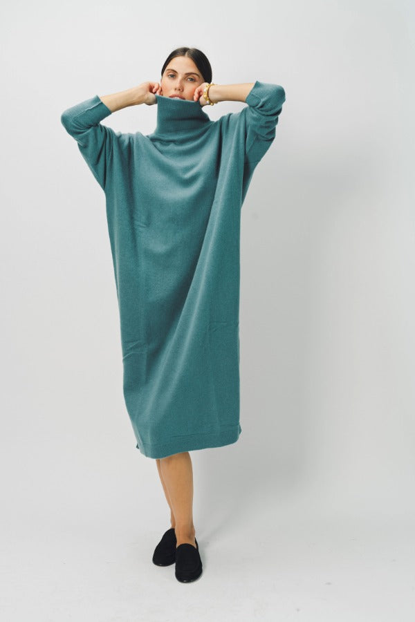 Alternate front view f norfolk blue iconic cashmere t-neck dress on model wearing loafers, against a white background.