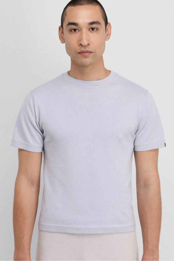 Front view of heaven cuba top on model wearing white pants, against a white background