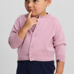 Front view of rosa no 440 toddler cardigan on model wearing navy pants, against a white background.