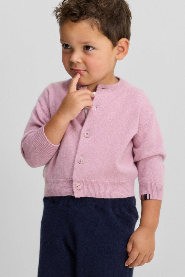 Front view of rosa no 440 toddler cardigan on model wearing navy pants, against a white background.