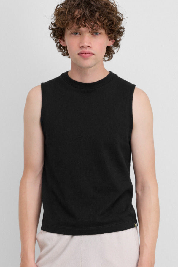 Front view of raven player top on model wearing white pants, against a white background.