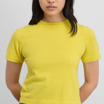 Front view of sunny tina top on black haired model wearing grey skirt.