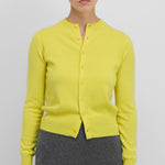 Front view of sunny little 2 top on model wearing grey pants, against a white background.
