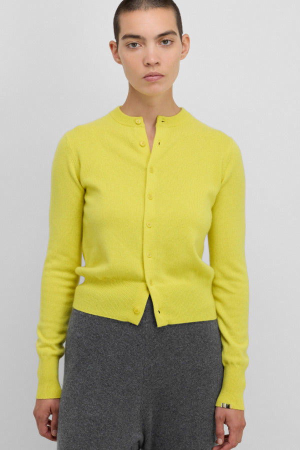 Front view of sunny little 2 top on model wearing grey pants, against a white background.