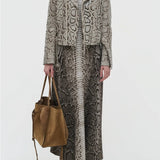 Front view of greyscale aalia dress on model wearing animal print jacket and boots, against a white background.