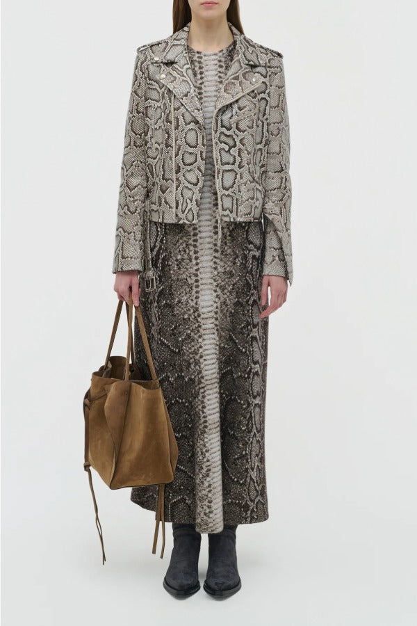 Front view of greyscale aalia dress on model wearing animal print jacket and boots, against a white background.