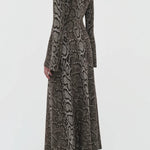Back view of greyscale aalia dress on model wearing boots, against a white background.