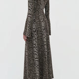 Back view of greyscale aalia dress on model wearing boots, against a white background.