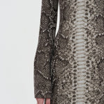 Side closeup view of greyscale aalia dress on model, against a white background.