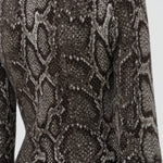 Back view of greyscale aalia dress on model, against a white background.
