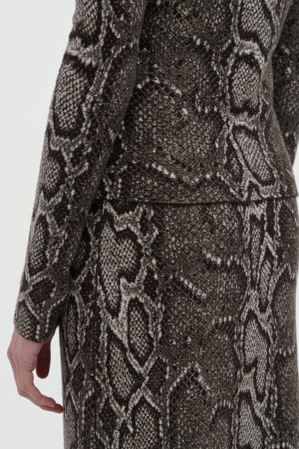 Back closeup view of greyscale bragi skirt on model wearing greyscale top, against a white background.