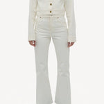 Front view of white bronte jacket on model wearing white pants and boots, against a white background.