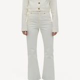 Front view of white bronte jacket on model wearing white pants and boots, against a white background.