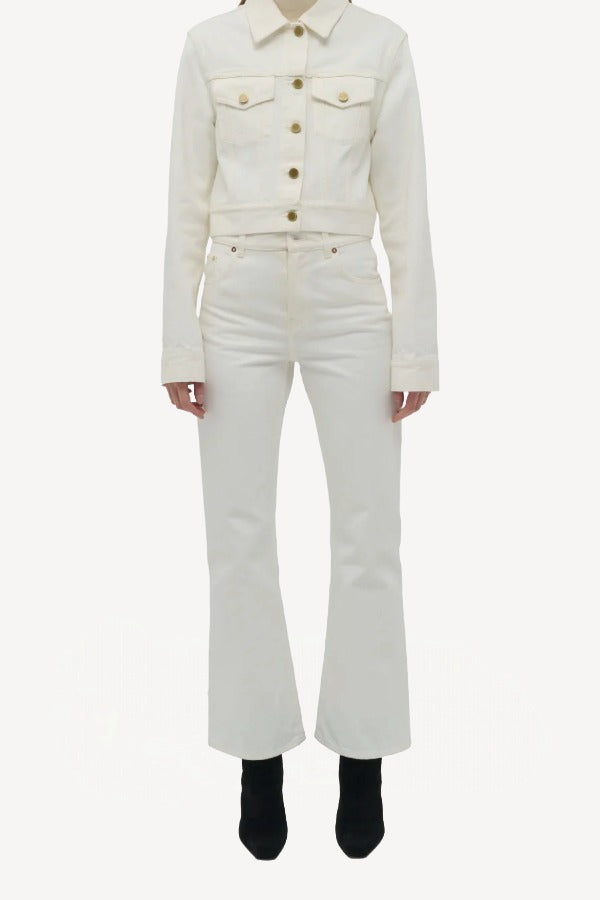 Front view of white bronte jacket on model wearing white pants and boots, against a white background.