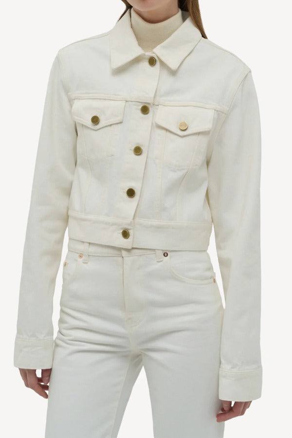 Front closeup view of white bronte jacket on model wearing white pants, against a white background.