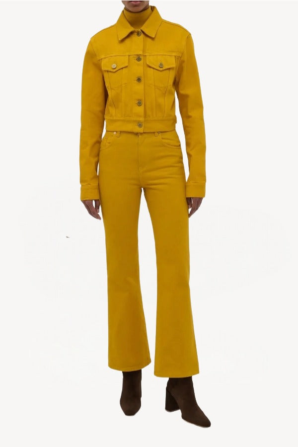 Front view of golden birch ezra bootcut jean on model wearing golden birch jacket and boots, against a white background.