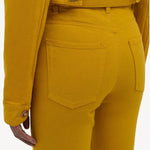 Back closeup view of golden birch ezra bootcut jean on model wearing golden birch jacket, against a white background.