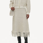 Front view of white odin bomber jacket on model wearing the white Bennie skirt and boots, against a white background.