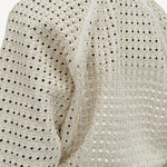 Back closeup view of white odin bomber jacket on model wearing white bennie skirt, against a white background.