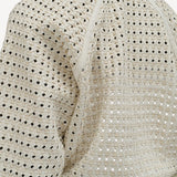 Back closeup view of white odin bomber jacket on model wearing white bennie skirt, against a white background.
