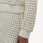 Front closeup view of white odin bomber jacket on model wearing white bennie skirt, against a white background.