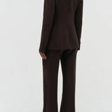 Back view of chocolate stephanie blazer on model wearing chocolate pants, against a white background.