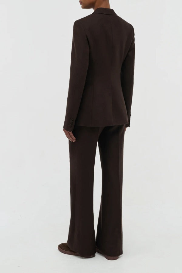 Back view of chocolate stephanie blazer on model wearing chocolate pants, against a white background.
