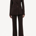 Front view of chocolate vesta pant on model wearing chocolate stephanie blazer and sneakers, against a white background.