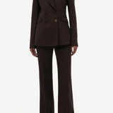Front view of chocolate vesta pant on model wearing chocolate stephanie blazer and sneakers, against a white background.