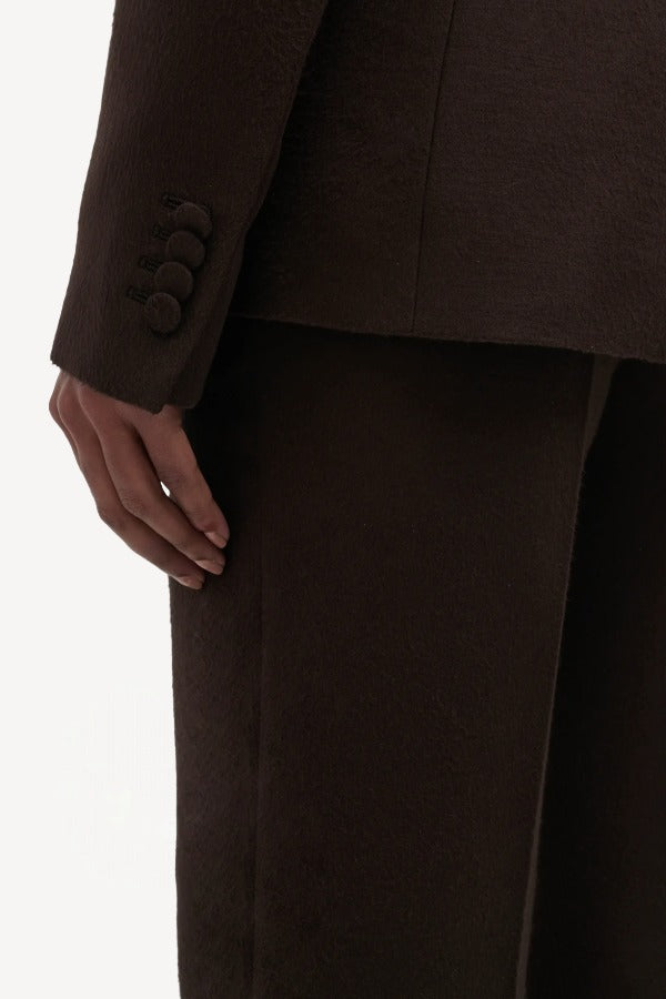 Back closeup of chocolate vesta pants on model wearing chocolate stephanie blazer, against a white background.