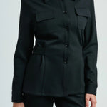 Front view of black gea shirt on model wearing black pants, against a white background.