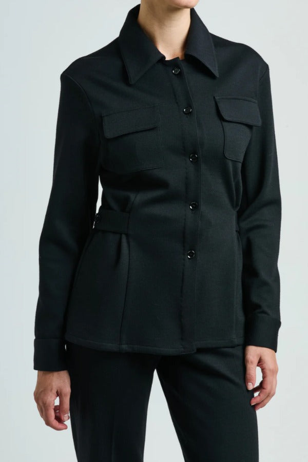 Front view of black gea shirt on model wearing black pants, against a white background.