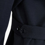 Side closeup view of black gea shirt on model, against white background.