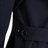 Side closeup view of black gea shirt on model, against white background.