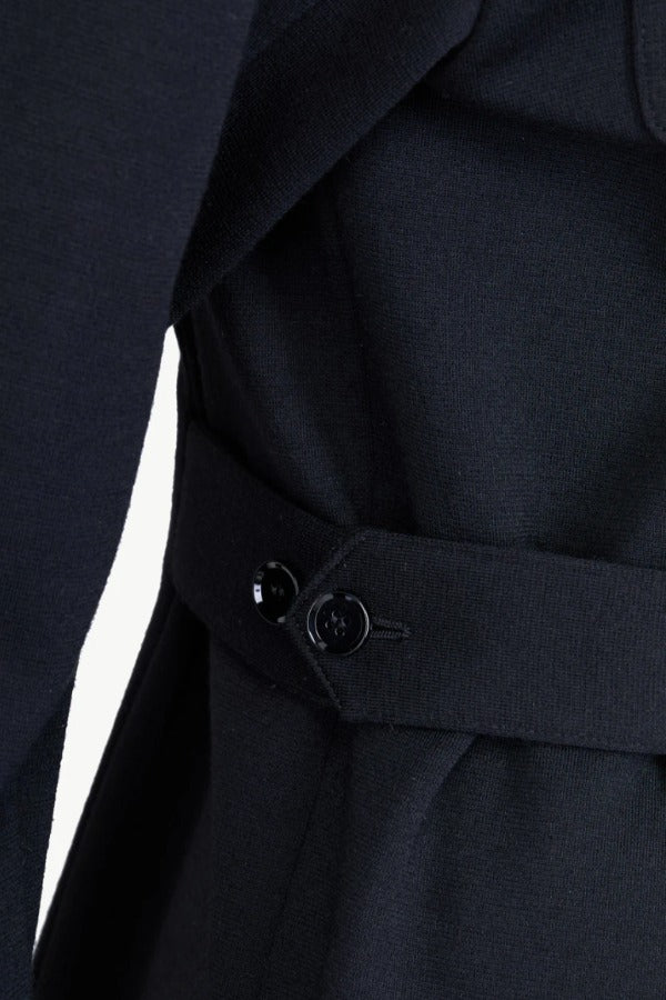 Side closeup view of black gea shirt on model, against white background.