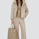 Front open view of chantilly cape jacket on model wearing beige pants and inner jacket, against white background.