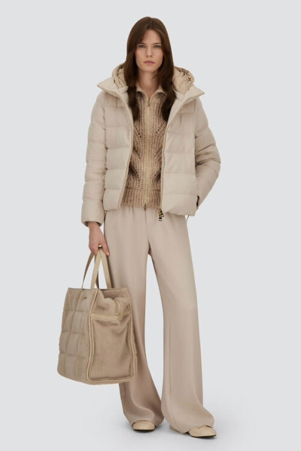 Front open view of chantilly cape jacket on model wearing beige pants and inner jacket, against white background.