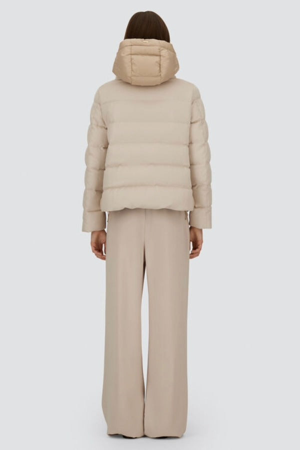 Back view of chantilly cape jacket on model wearing beige pants, against a white background.
