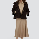 Front view of opened cape on model wearing chantilly dress and flats, against a white background.