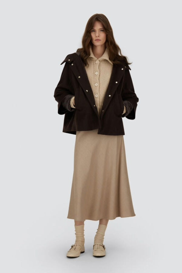 Front view of opened cape on model wearing chantilly dress and flats, against a white background.