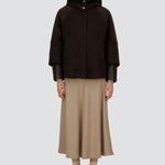 Front view of closed cape jacket on model wearing chantilly dress and flats, against a white background.