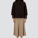 Front view of closed cape jacket on model wearing chantilly dress and flats, against a white background.