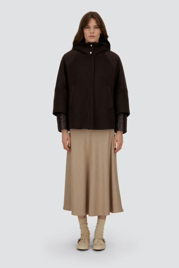 Front view of closed cape jacket on model wearing chantilly dress and flats, against a white background.