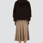 Back view of fondante cape on model wearing chantilly dress and flats, against a white background.