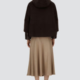 Back view of fondante cape on model wearing chantilly dress and flats, against a white background.