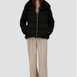 Front open view of black jacket in arendelle on model wearing beige pants, against a white background.