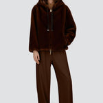 Front view of fondante knitted jacket on model wearing chocolate pants and flats, against a white background.