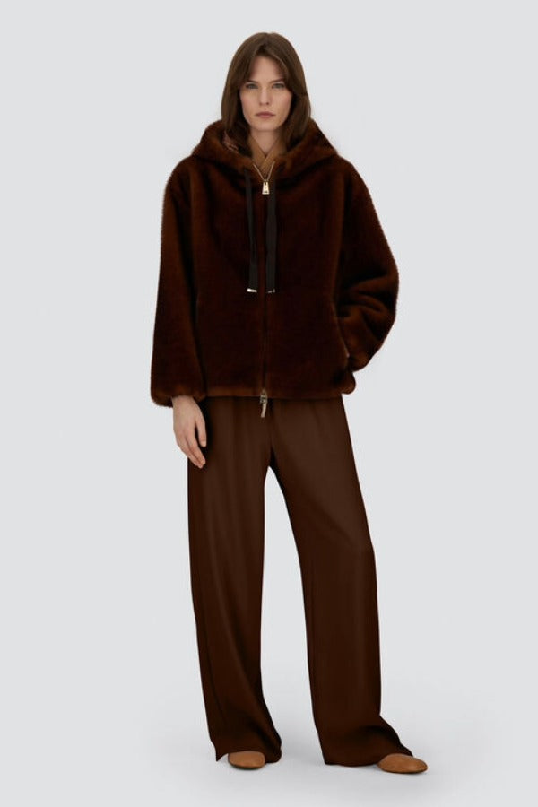 Front view of fondante knitted jacket on model wearing chocolate pants and flats, against a white background.